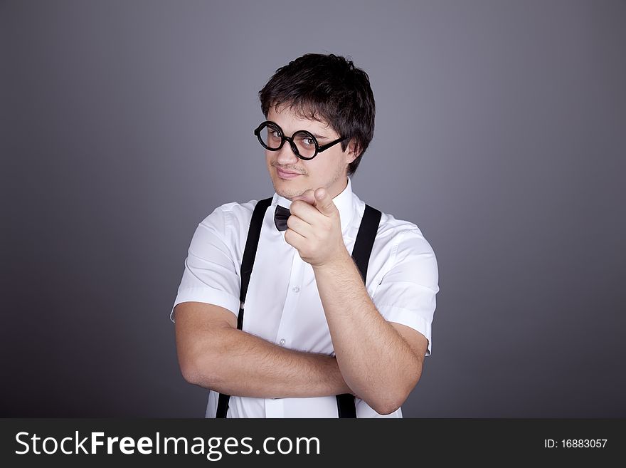 Portrait of funny fashion men in suspender with bow tie and glasses. Studio shot.