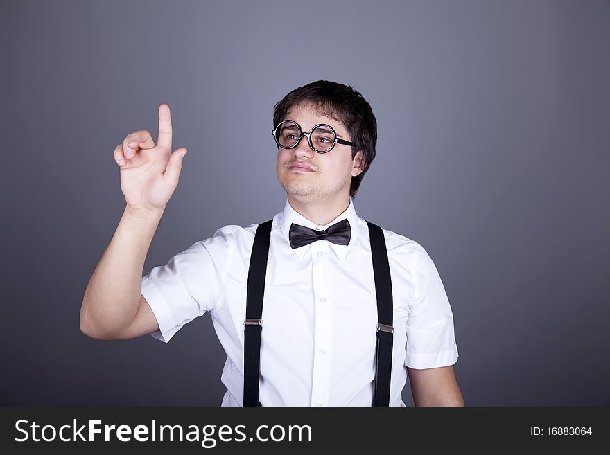 Portrait of funny fashion men in suspender with bow tie and glasses. Studio shot.