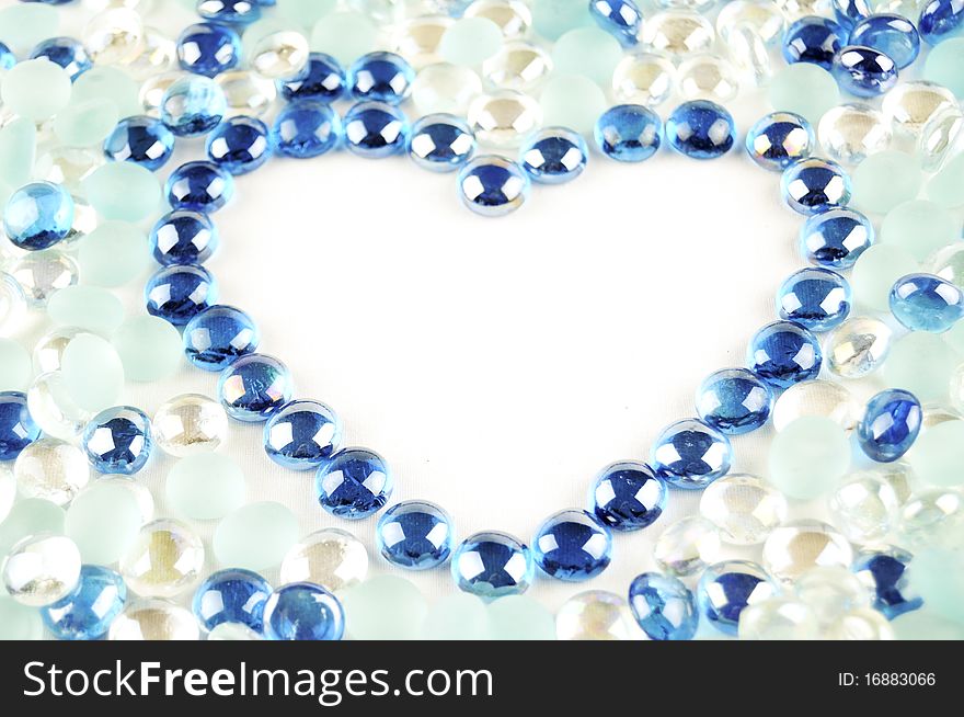 Heart frame from shiny glass marbles
