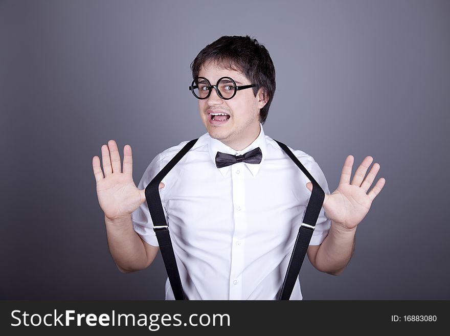 Portrait of funny fashion men in suspender with bow tie and glasses. Studio shot.