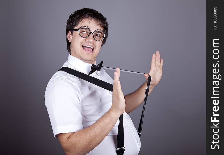 Portrait of funny fashion men in suspender with bow tie and glasses. Studio shot.