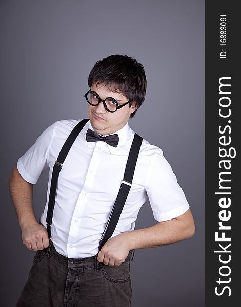 Portrait of funny fashion men in suspender with bow tie and glasses. Studio shot.