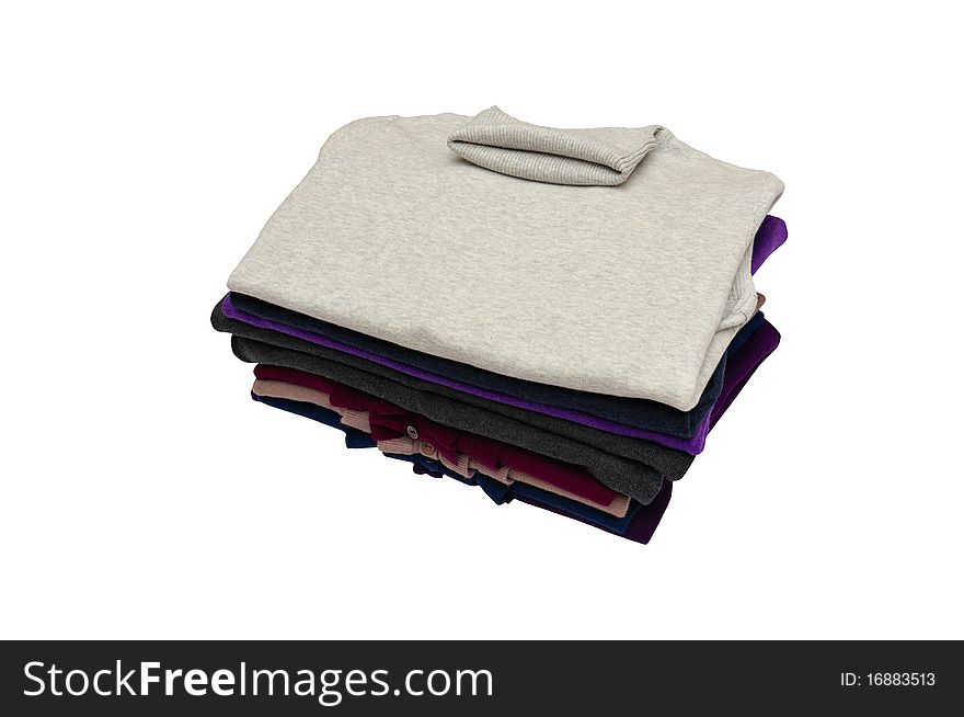 Small heap of modern sweaters isolated on a white background. Small heap of modern sweaters isolated on a white background.