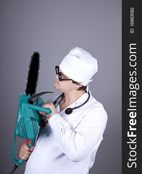 Crazy doctor with portable saw.