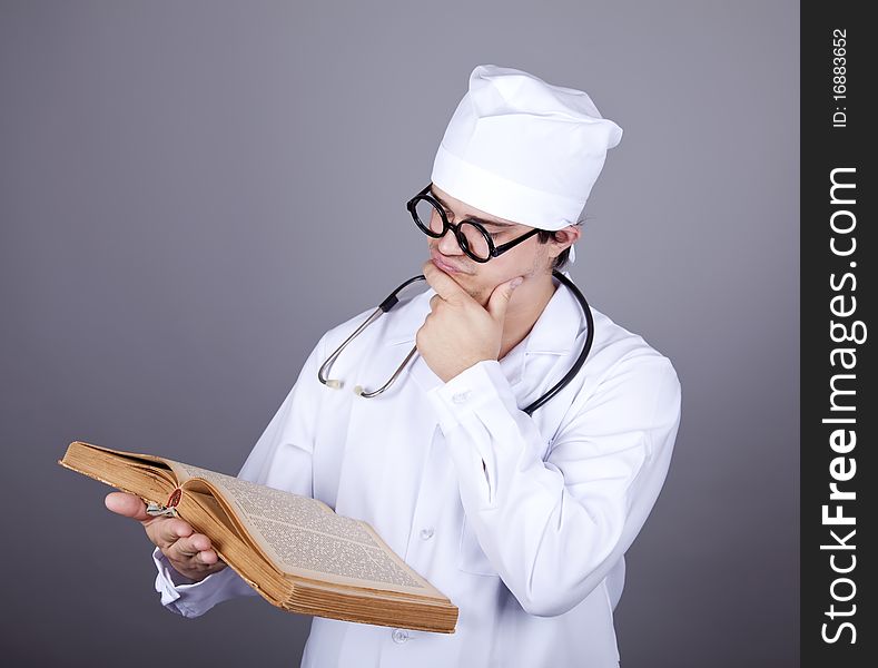 Young doctor with book. Studio shot.