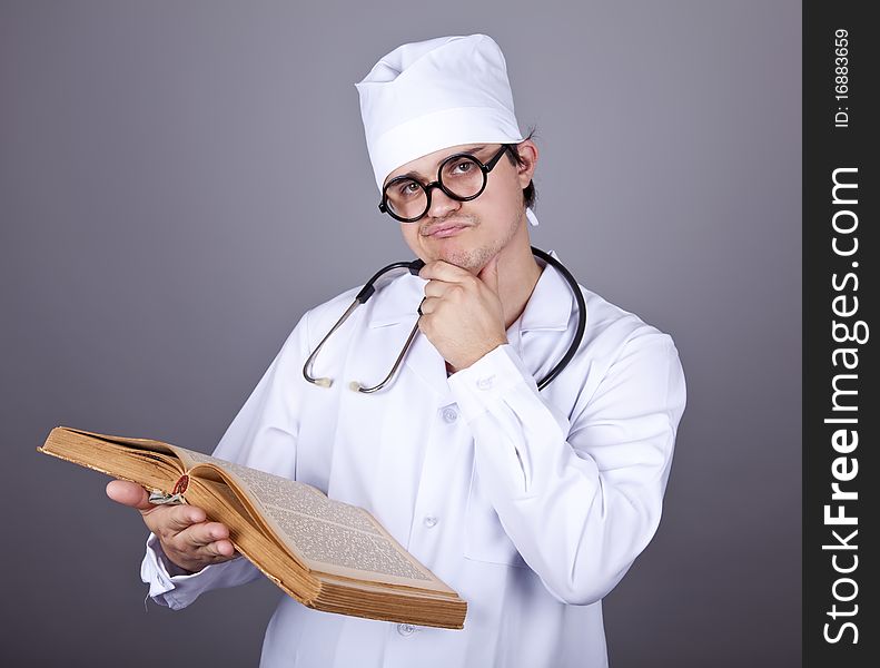 Young doctor with book. Studio shot.