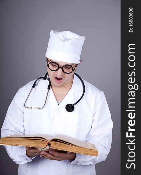 Young doctor with book. Studio shot.