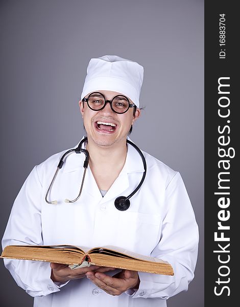 Young doctor with book. Studio shot.