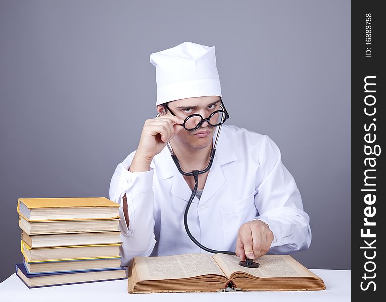 Young male doctor studying medical books