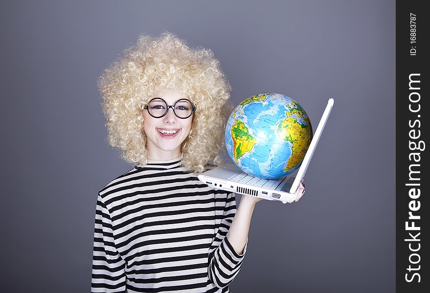 Funny girl in glasses keeping notebook and globe. Studio shot.