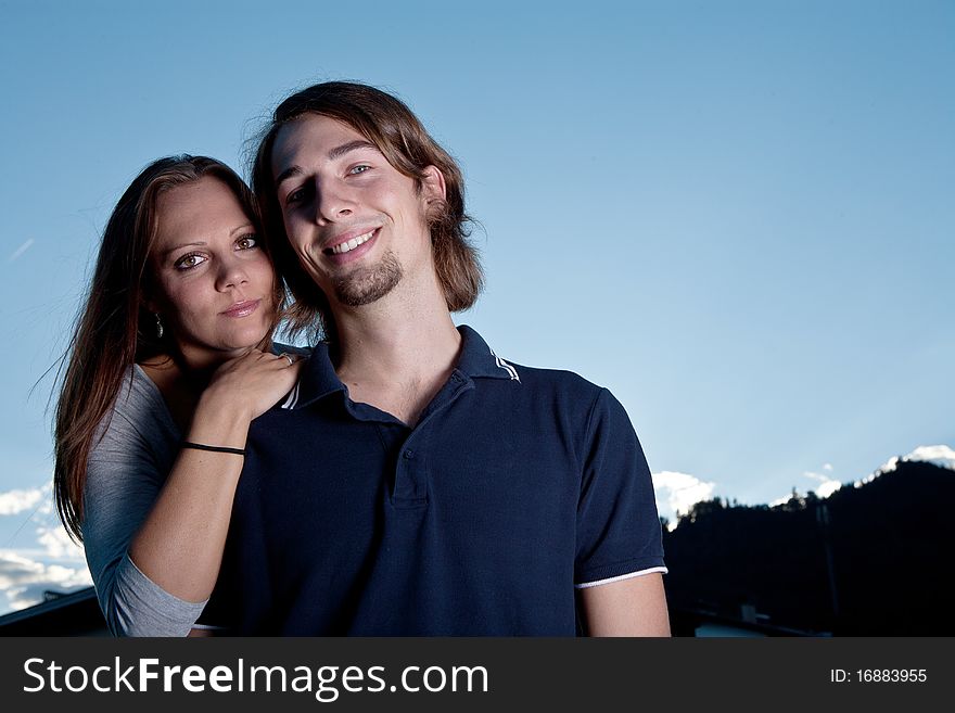 Young couple in love with blue sky in the background. Young couple in love with blue sky in the background