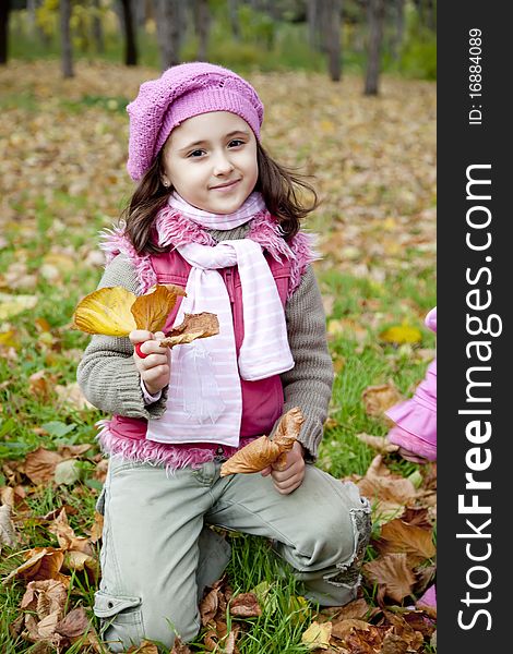 Cute Girl In Autumn Park