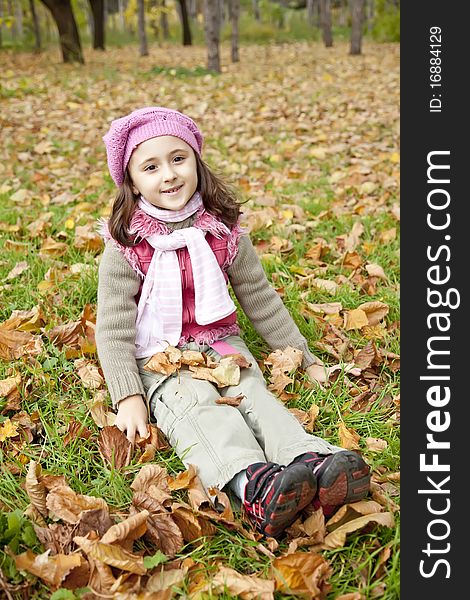 Cute girl in autumn park. Portrait shot.
