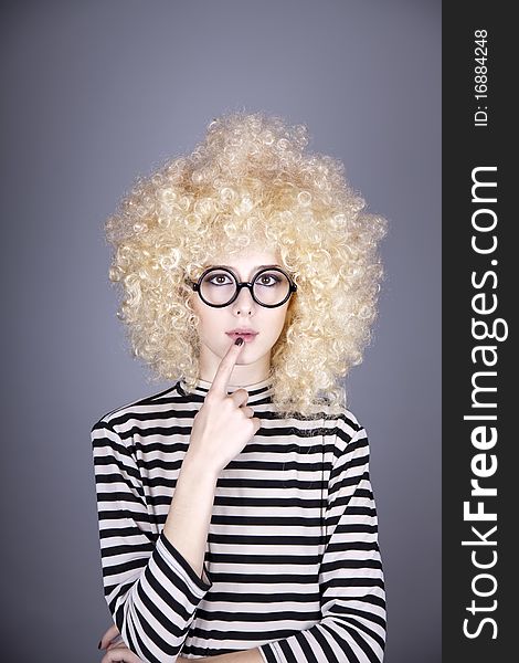 Portrait of funny girl in blonde wig. Studio shot.