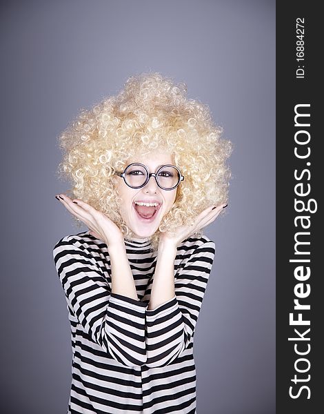 Portrait of funny girl in blonde wig. Studio shot.