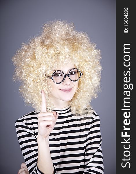 Portrait of funny girl in blonde wig.