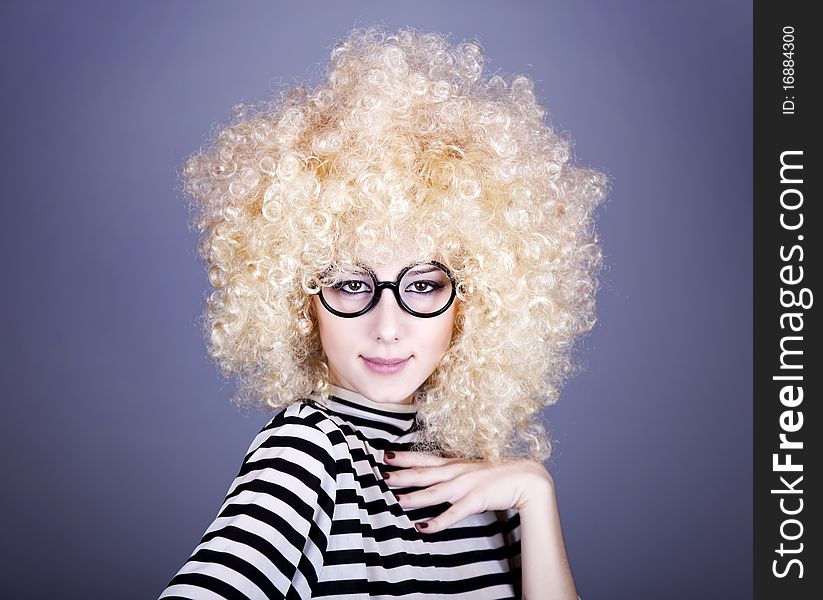 Portrait of funny girl in blonde wig.