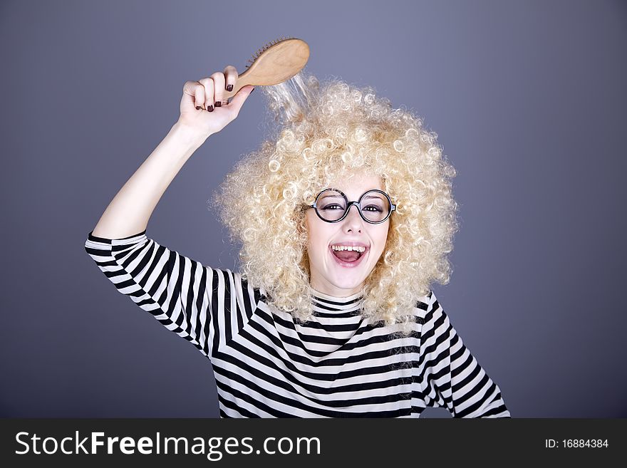 Surprised girl with comb. Studio shot.