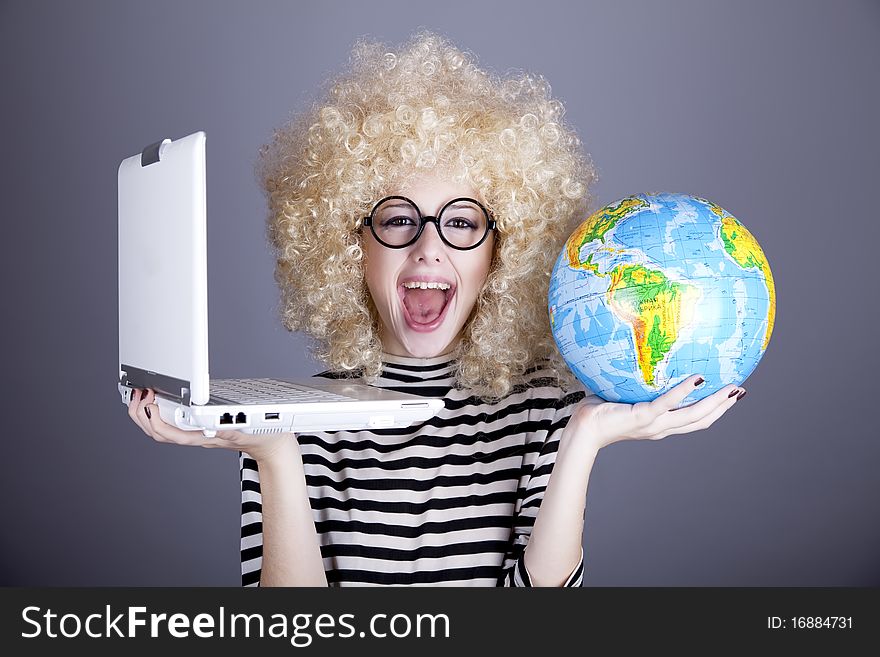 Funny girl in glasses keeping notebook and globe. Studio shot.