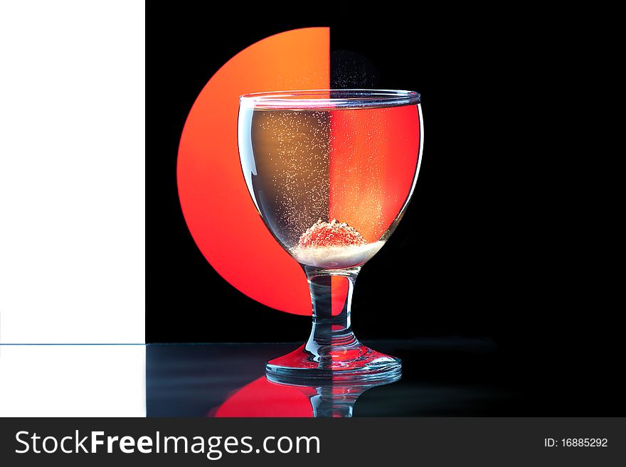 Glass goblet of wine, and berries on a colored background. Glass goblet of wine, and berries on a colored background.