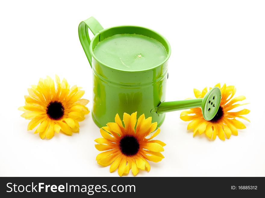 Green watering can with sunflowers