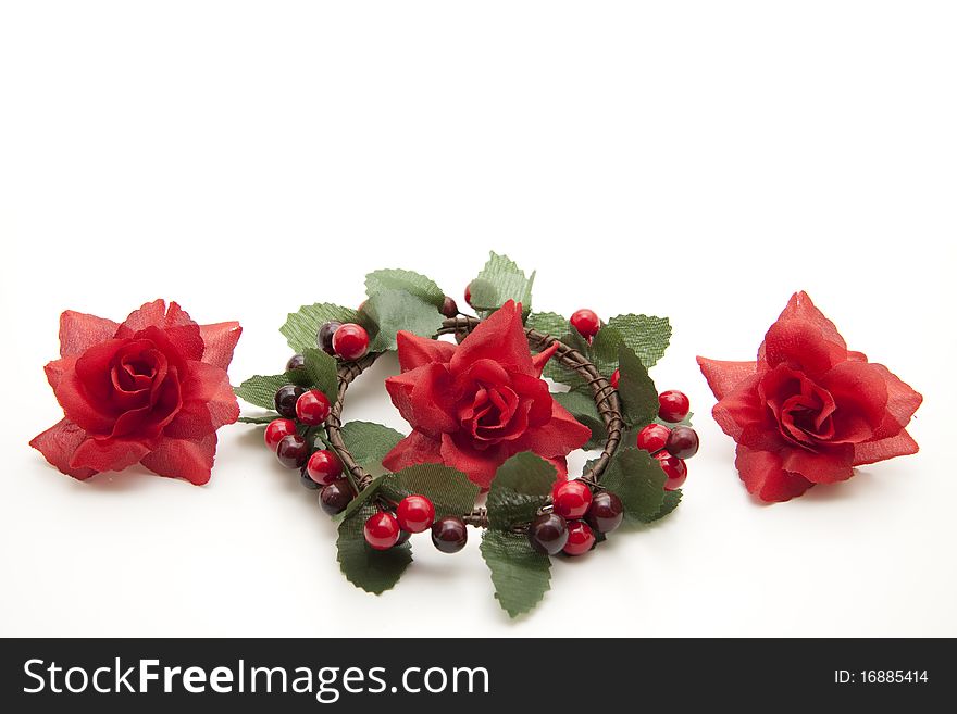 Red roses and wreath with berries