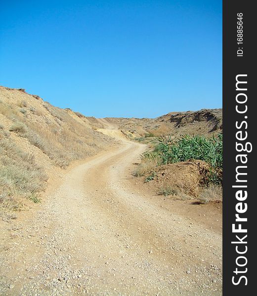 Deserted road in sandy hills. Black sea coastline. Deserted road in sandy hills. Black sea coastline.