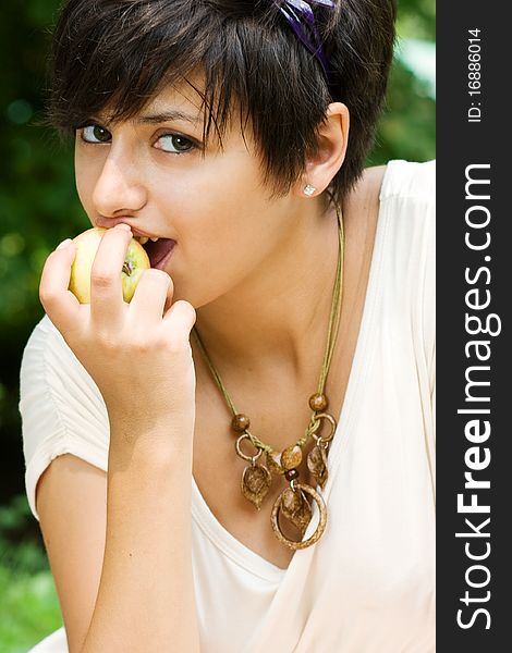 Pretty girl eating an apple