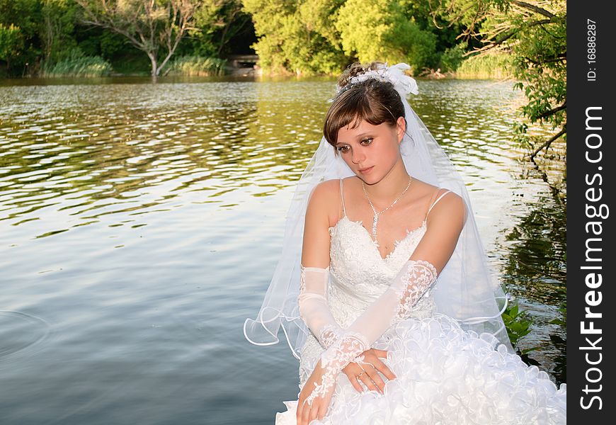 Bride longs at the lake