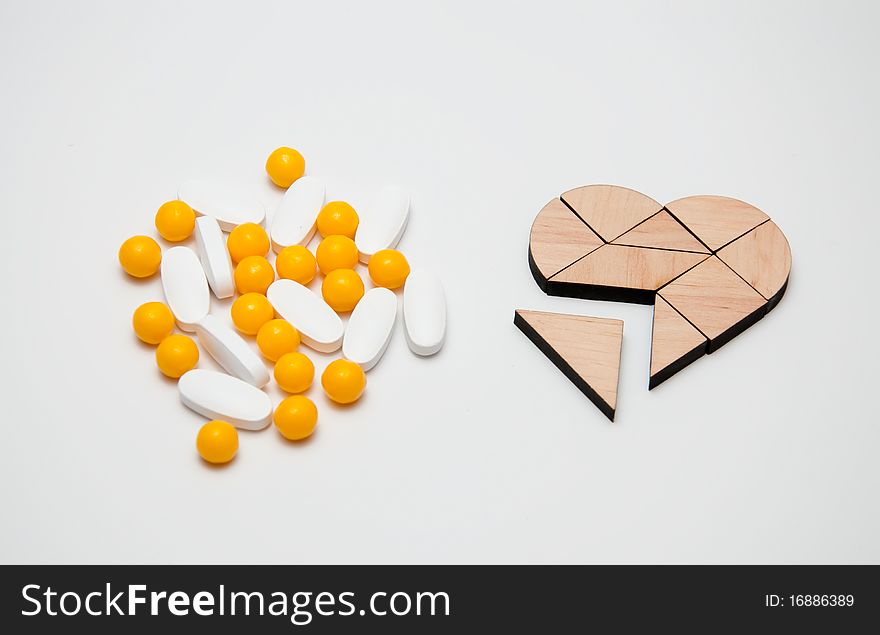 Yellow and white tablets near the heart. Yellow and white tablets near the heart