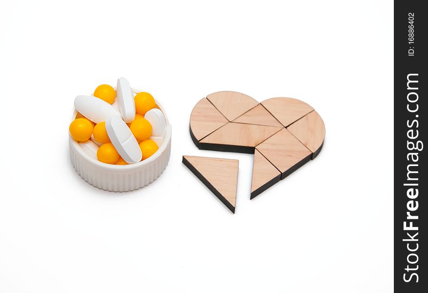 Yellow and white tablets near the heart. Yellow and white tablets near the heart