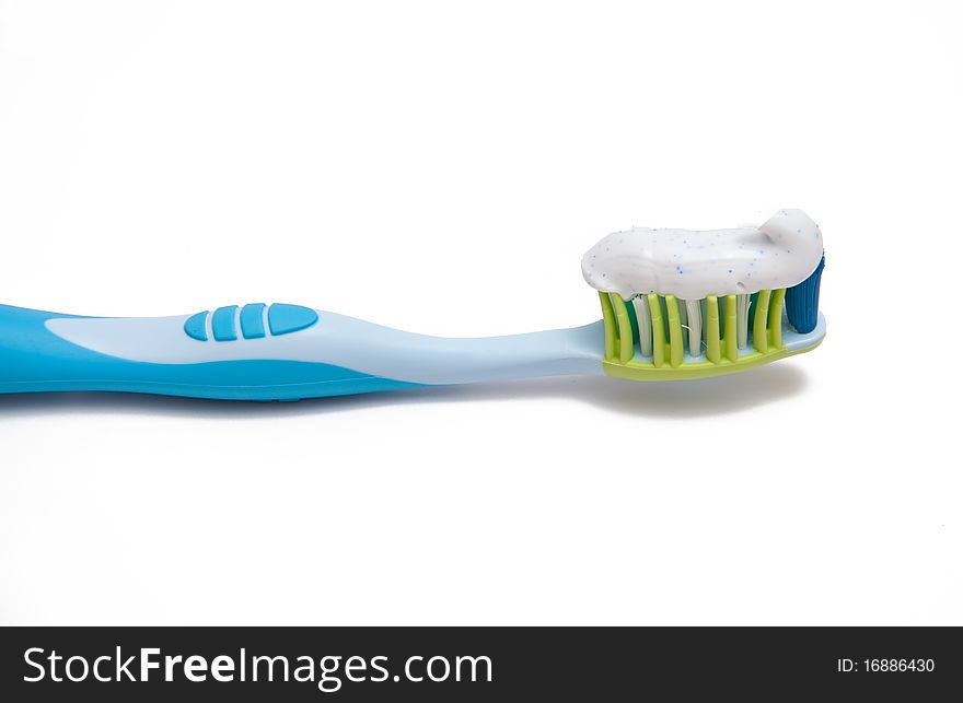 Toothbrush and toothpaste on a white background