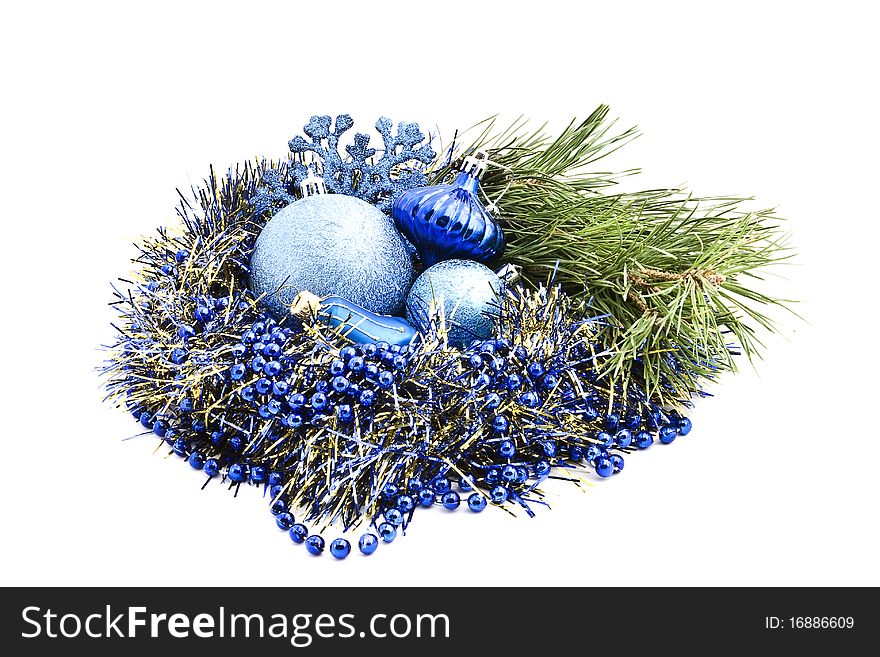 A wreath of garland, pine branches and beautiful holiday toys on a white background. A wreath of garland, pine branches and beautiful holiday toys on a white background.