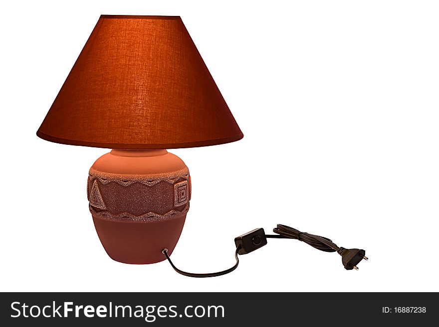 Red lamp with a shade on the isolated background