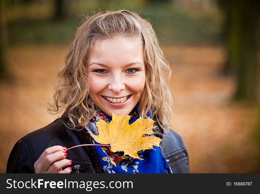 Young caucasian student girl in golden autumn park. Young caucasian student girl in golden autumn park
