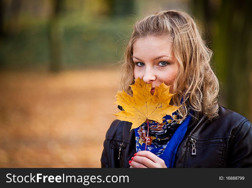 Young caucasian student girl in golden autumn park. Young caucasian student girl in golden autumn park