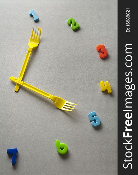 Yellow forks used as clock hands. Yellow forks used as clock hands
