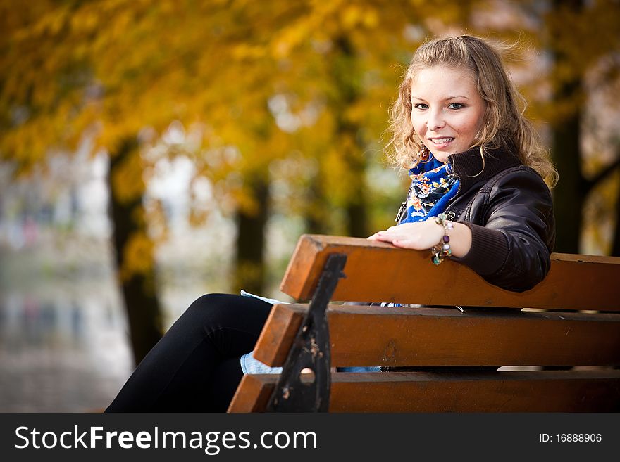 Young caucasian student girl in golden autumn park. Young caucasian student girl in golden autumn park