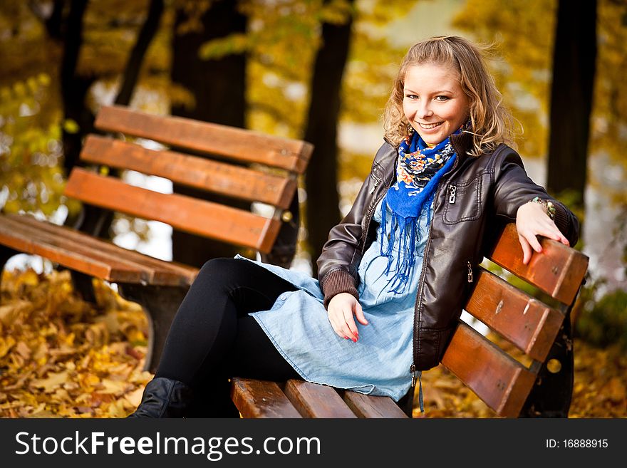 Young caucasian student girl in golden autumn park. Young caucasian student girl in golden autumn park