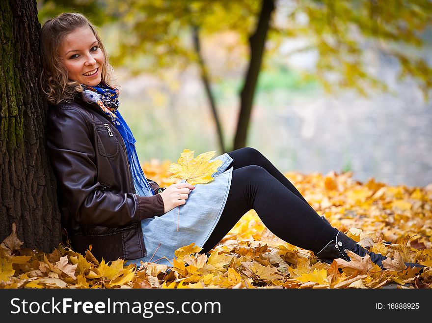 Young caucasian student girl in golden autumn park. Young caucasian student girl in golden autumn park