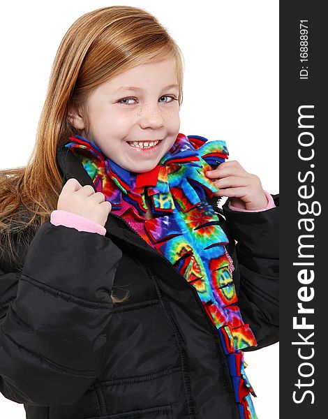 Beautiful 5 year old girl with blond hair blue eyes wearing winter coat and colorful scarf. Beautiful 5 year old girl with blond hair blue eyes wearing winter coat and colorful scarf.