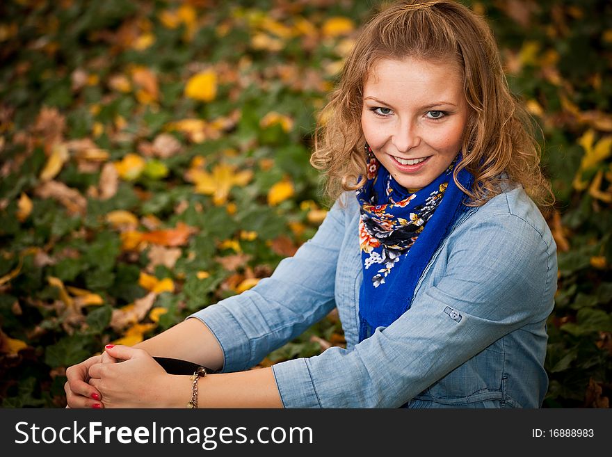 Young caucasian student girl in golden autumn park. Young caucasian student girl in golden autumn park