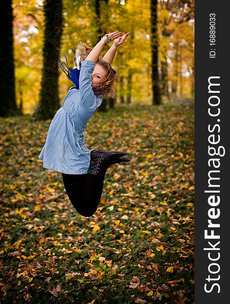 Young caucasian student girl in golden autumn park. Young caucasian student girl in golden autumn park