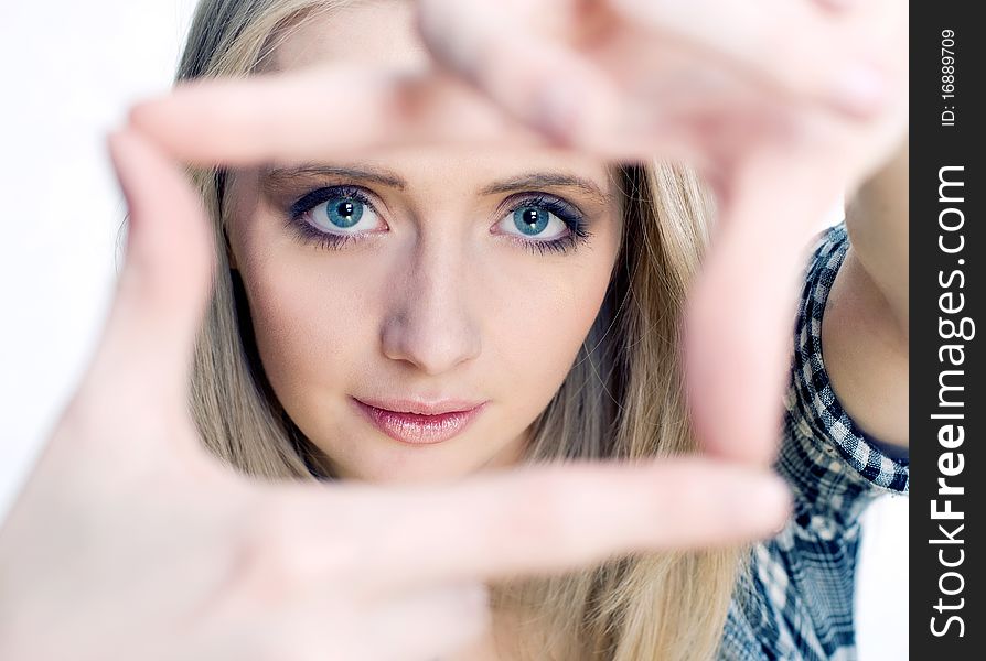 Young girl posing her hands like photo frame isolated on white. Young girl posing her hands like photo frame isolated on white