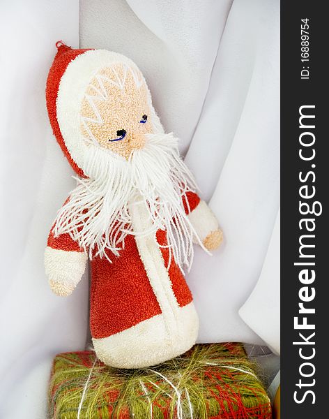 Old toy - Santa Clause on a background of white cloth