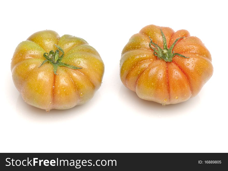 Two tomatoes on a white background