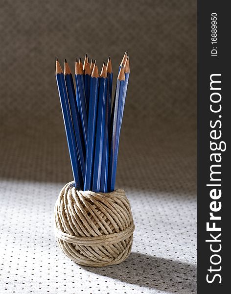 Bunch of pencils placed in a ball of twine