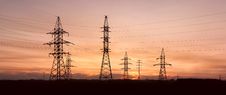 Electricity Pylons And Lines At Dusk. Royalty Free Stock Photography