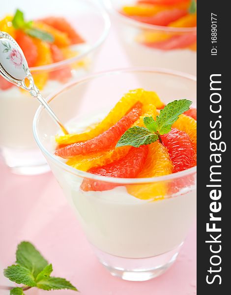 Panna cotta with orange and grapefruit in glasses