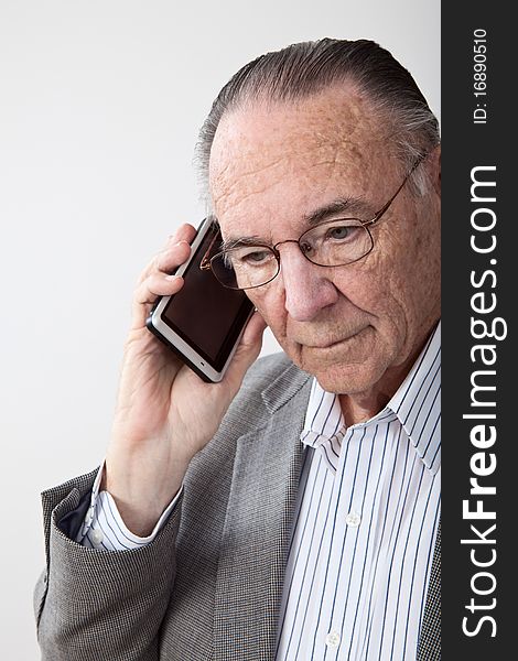 Mature man wearing coat and talking on cell phone. Mature man wearing coat and talking on cell phone.